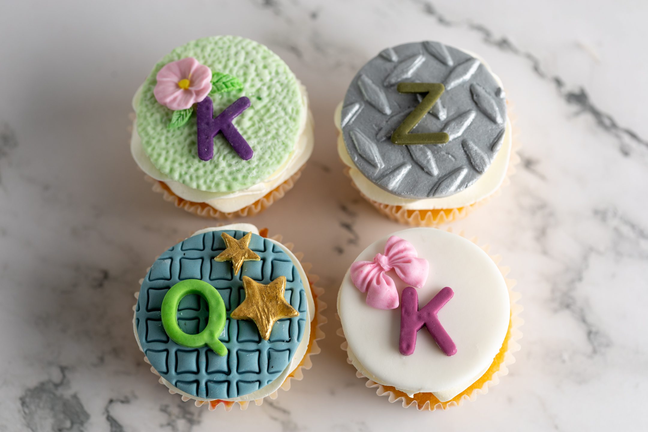 Sucré Bespoke Fondant Cupcakes — custom fondant toppers with detailed character work on celebration cupcakes