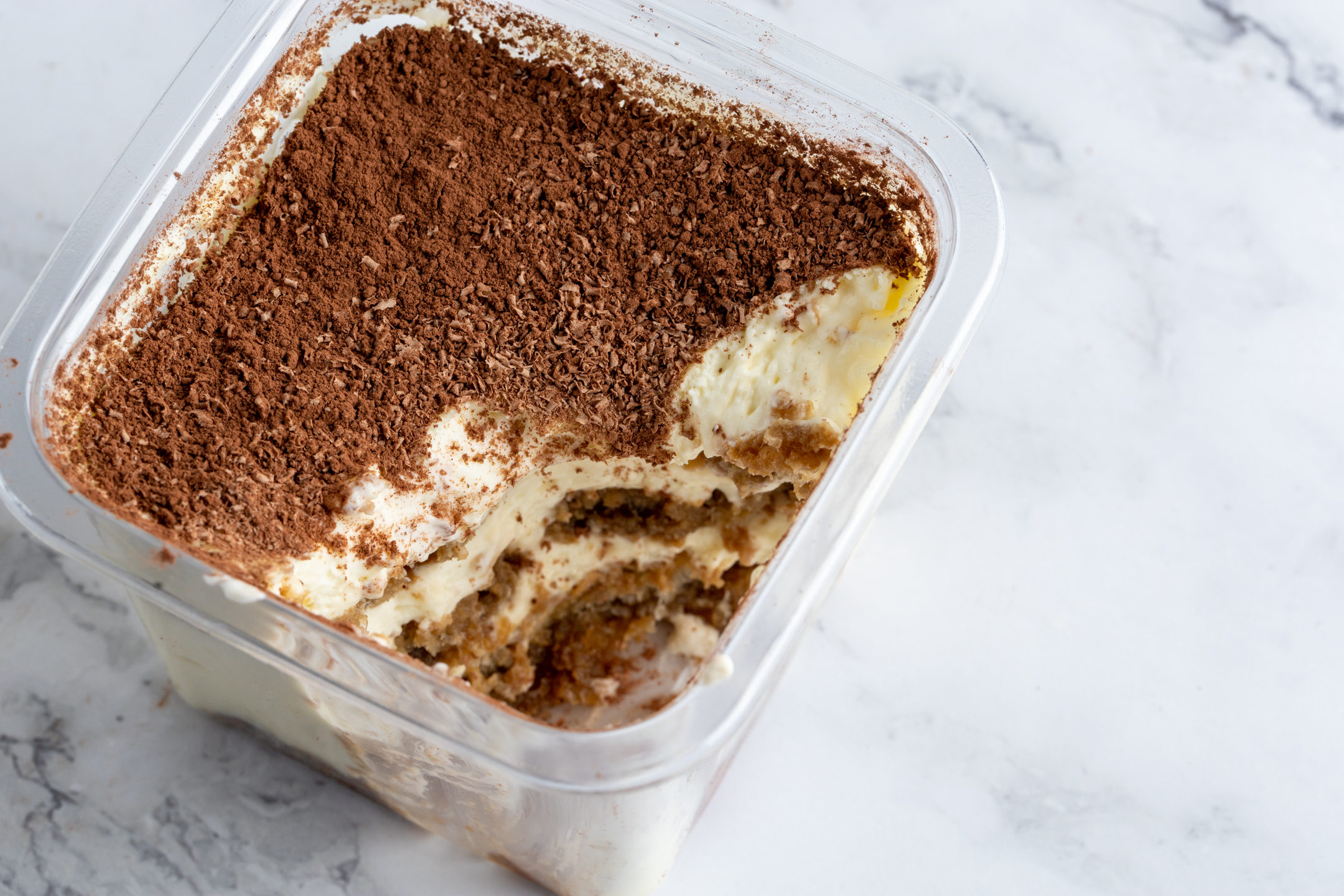 Tiramisu cross-section showing three layers of espresso-dipped Savoiardi and mascarpone cream