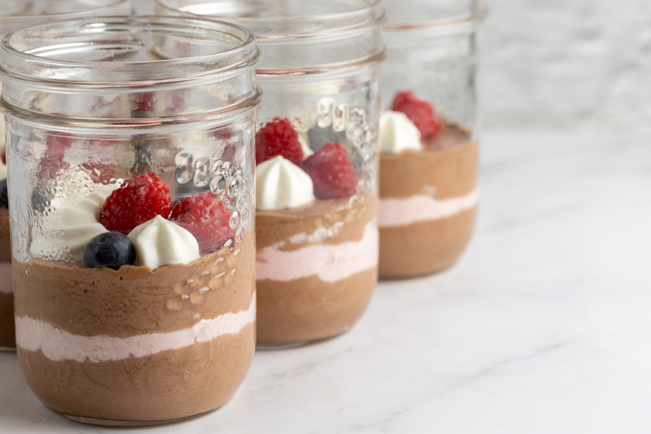 Belgian Couverture Chocolate Mousse showing raspberry cream stripe and berry topping