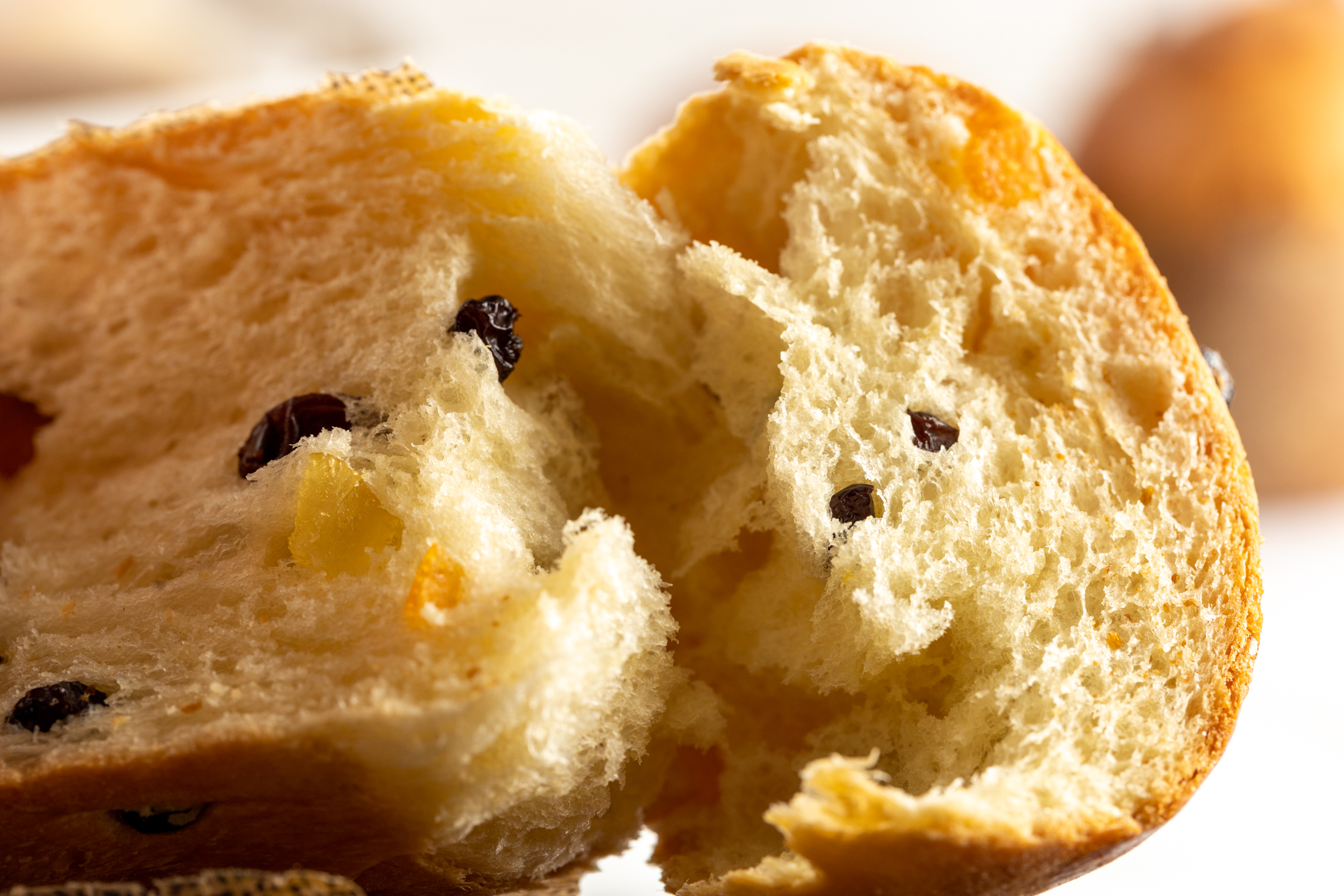 Mini Panettone cross-section showing buttery enriched dough with candied peel, raisins, cranberries and lemon zest