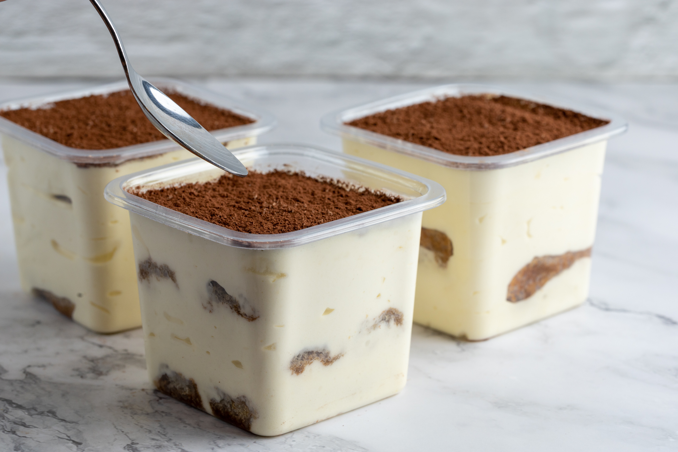 Individual Tiramisu portion dusted with cocoa and Belgian chocolate shavings by Sucré