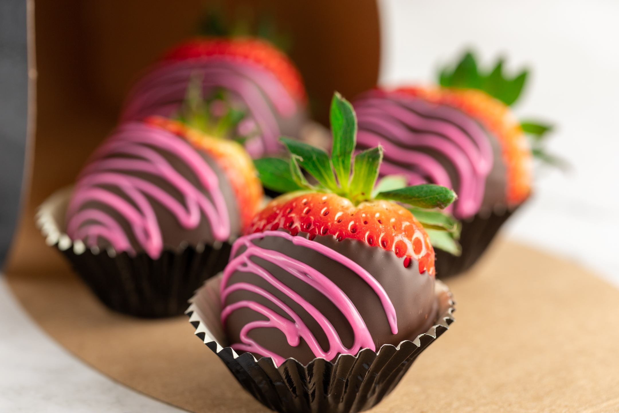 Hand-picked strawberries dipped in Belgian dark couverture chocolate on a platter
