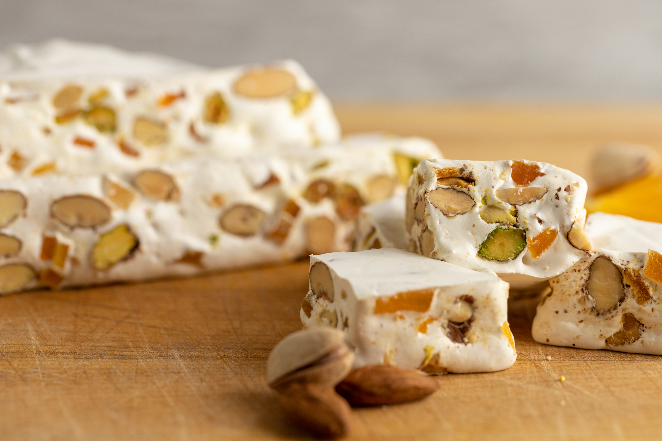 Nougat Montélimar cross-section showing pistachio and almond studded nougat interior with candied fruit