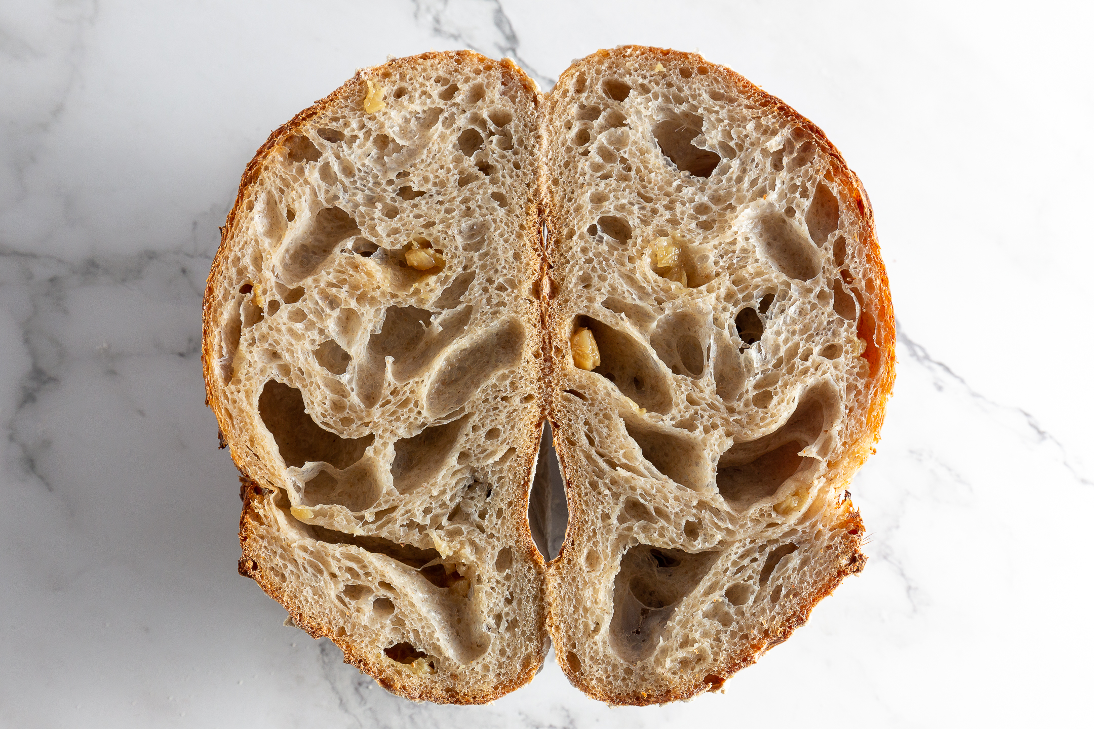 Sourdough Loaf cross-section showing open airy crumb and golden crackling crust