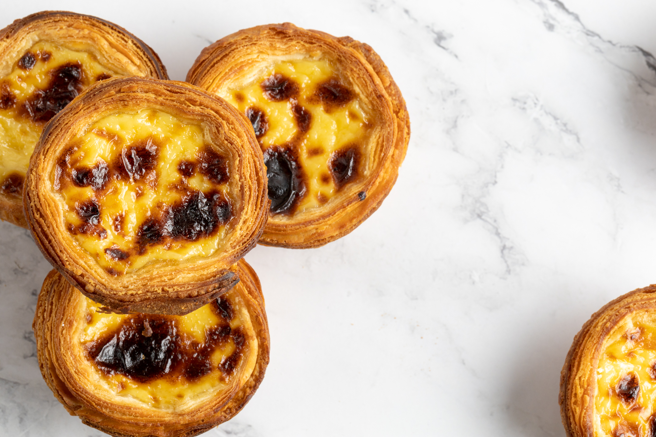 Portuguese Tarts by Sucré — caramelized blistered custard with all-butter crust