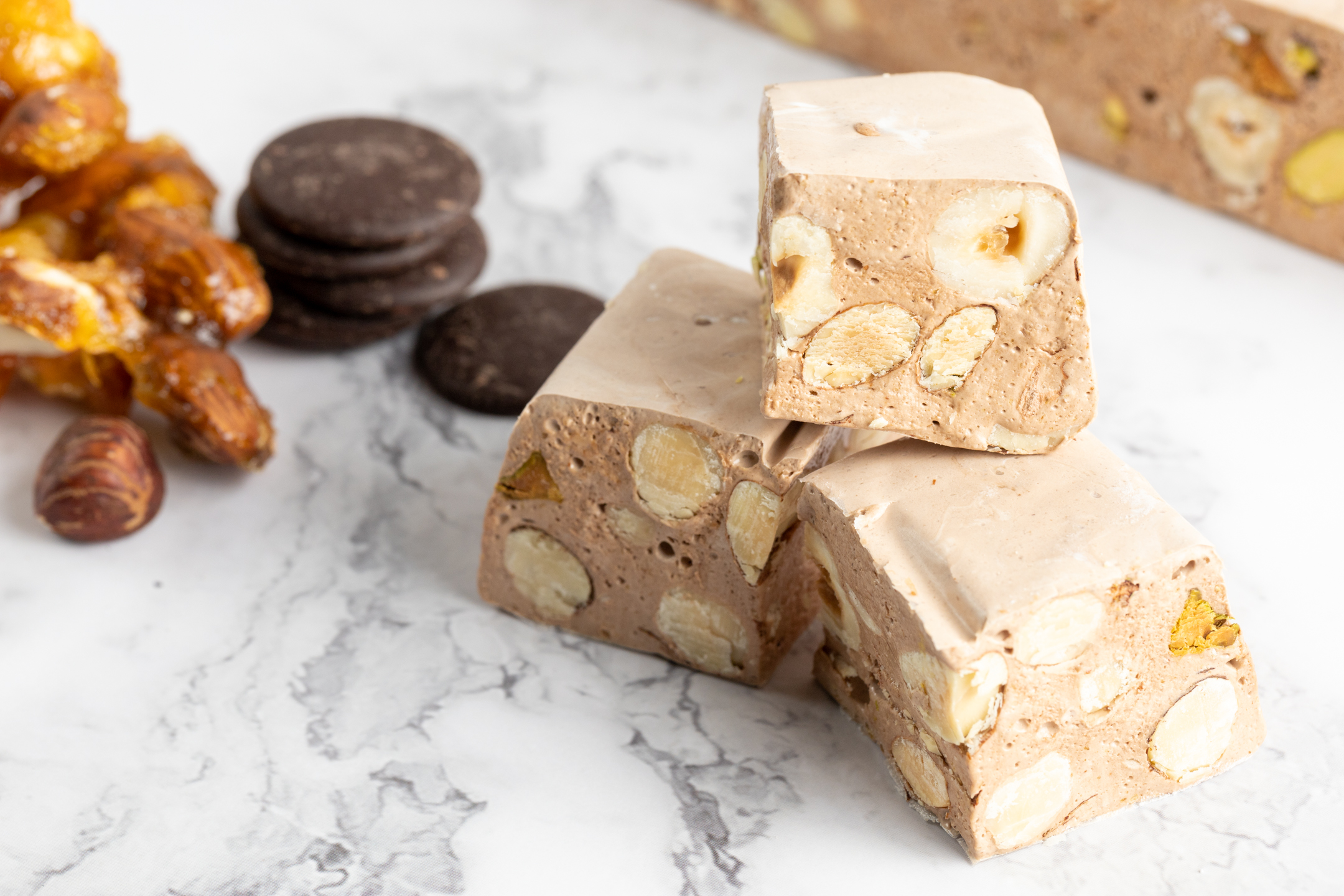 Nougat Gianduja close-up showing hazelnut, pistachio and almond studded interior