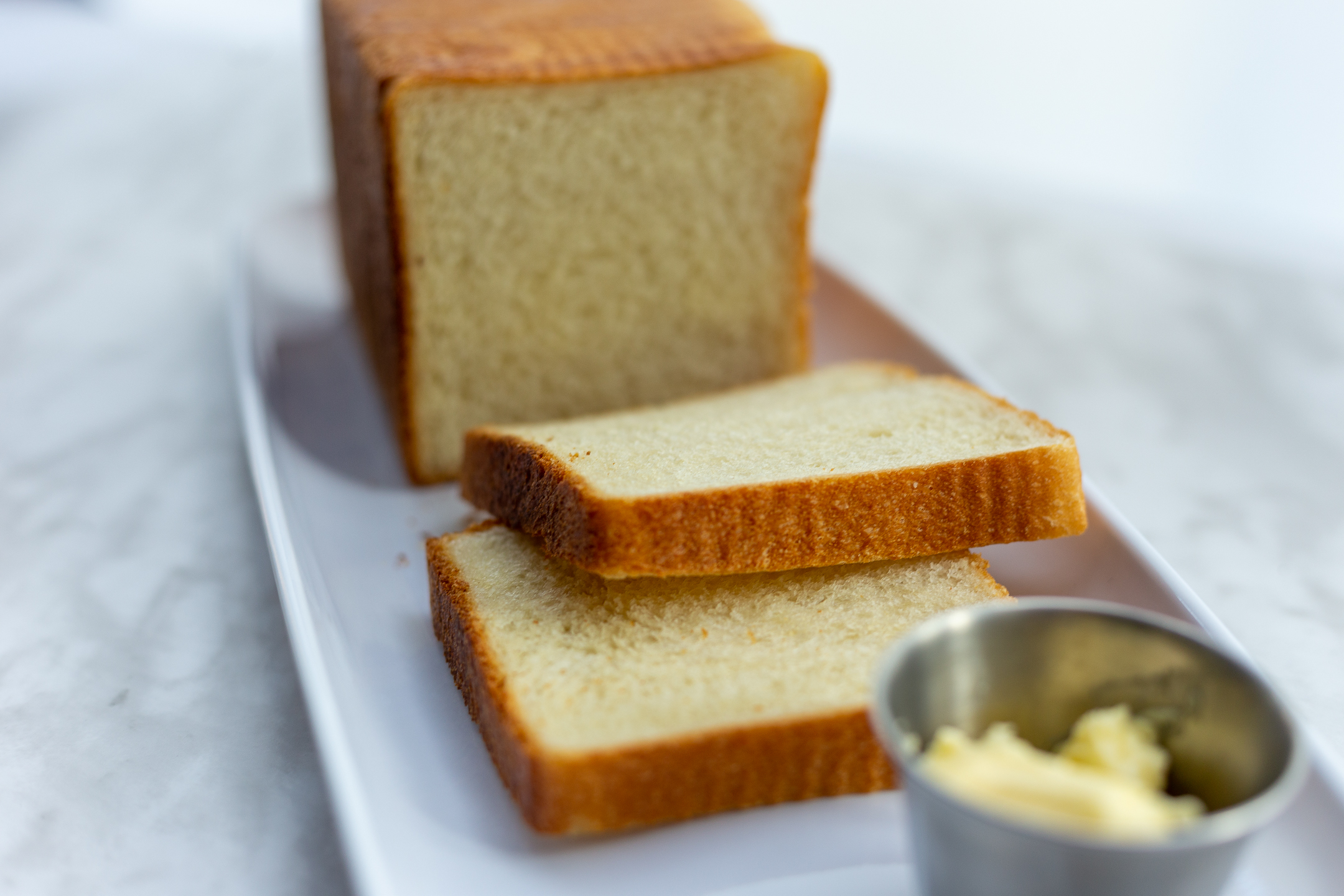 Japanese Milk Bread sliced to reveal pillowy soft interior