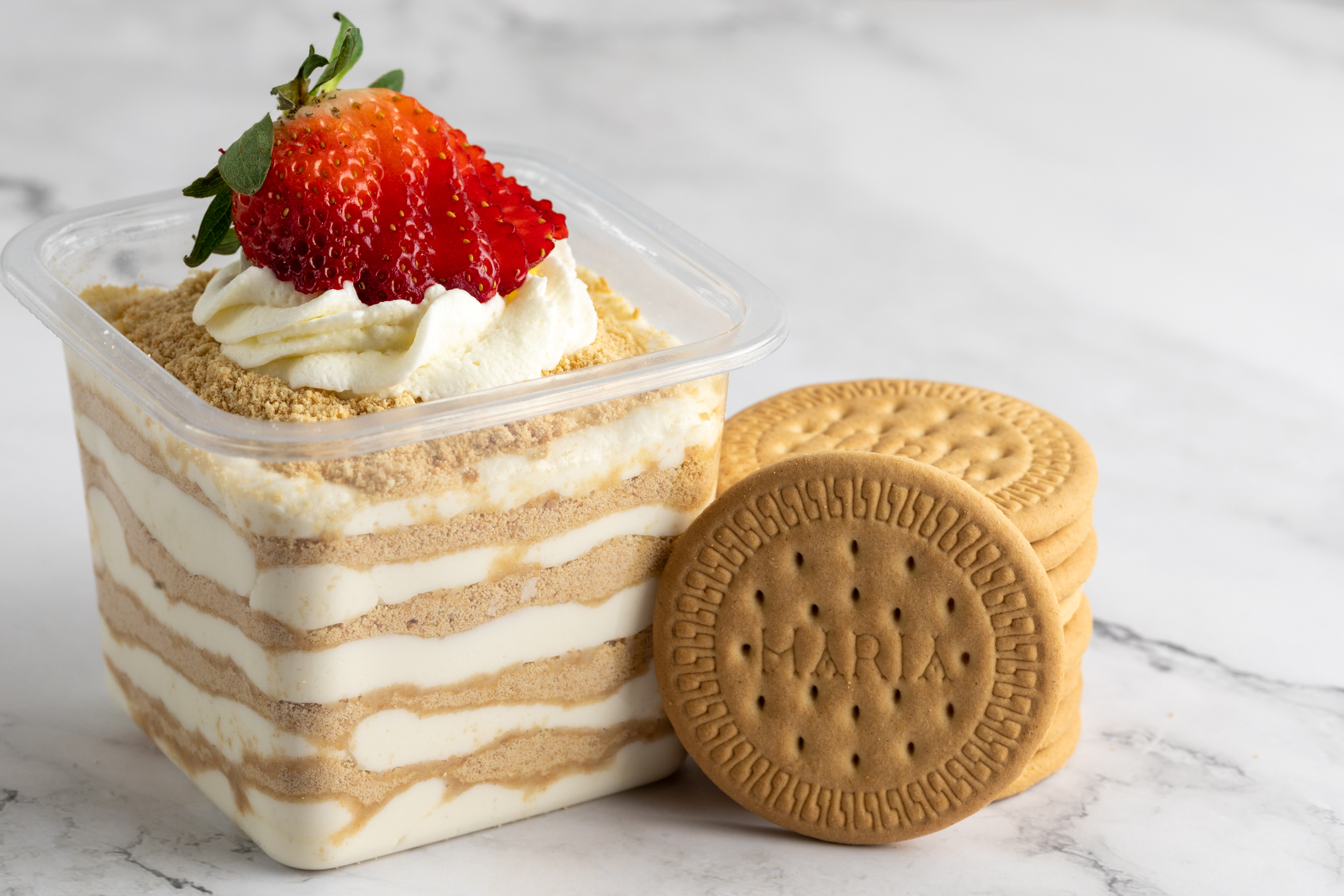 Serradura Portuguese sawdust pudding by Sucré — Maria biscuit crumbs layered with Chantilly cream and topped with fresh strawberries
