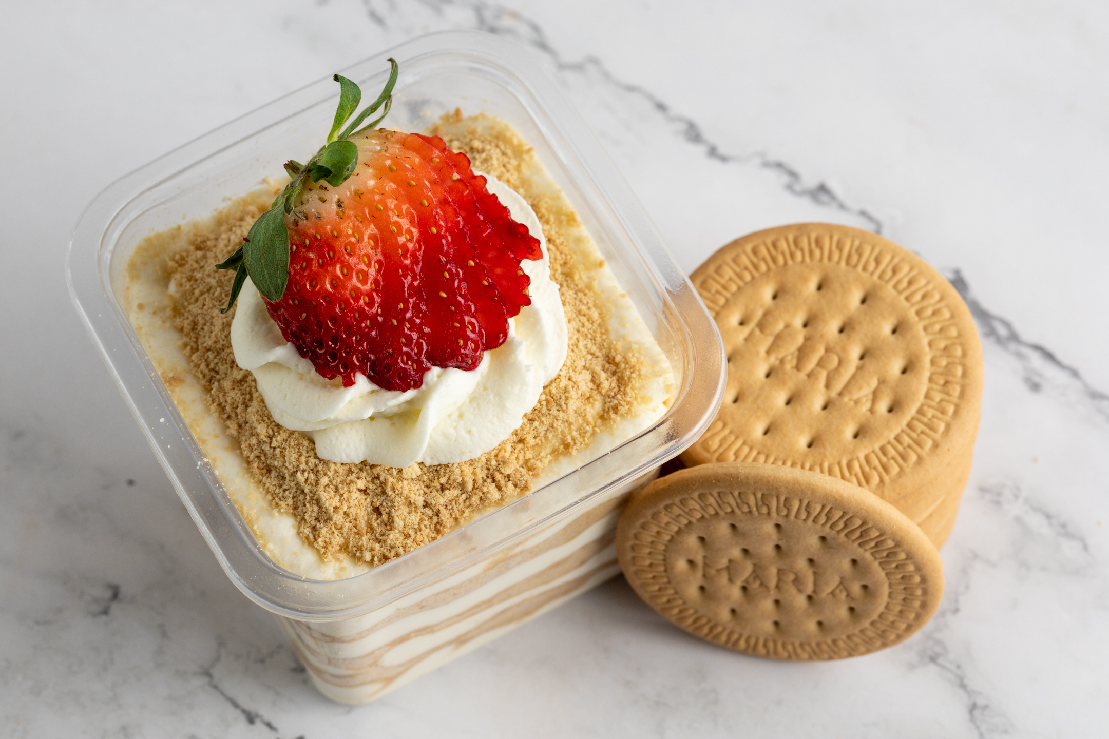 Serradura cross-section in 12 oz container showing alternating layers of crushed Maria biscuit and condensed milk cream