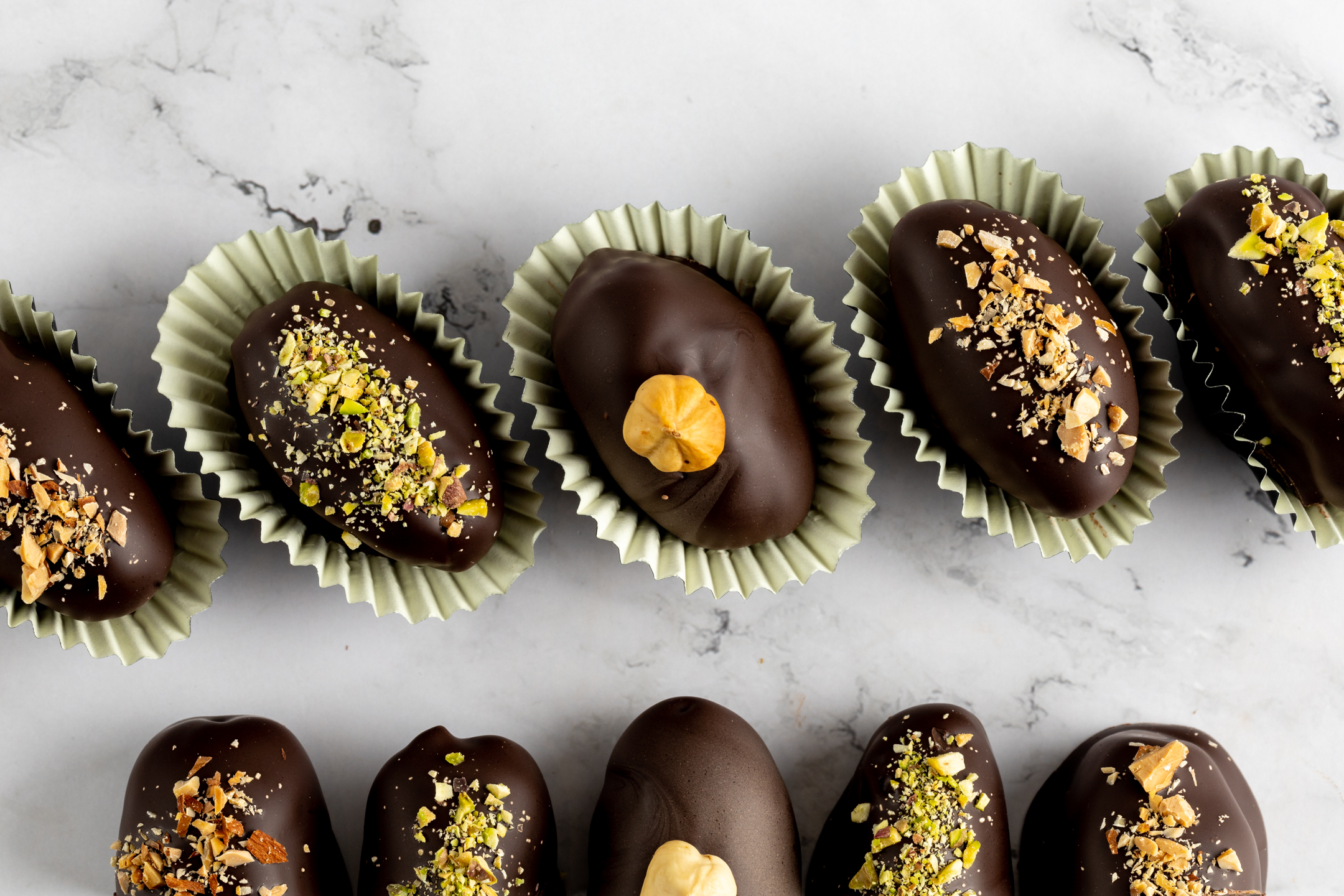 Date and Nut Truffles close-up showing Belgian couverture chocolate coating with hand-chopped nut finish