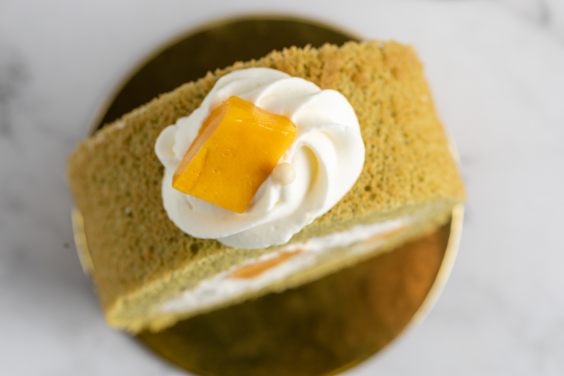 Mango Matcha Swiss Roll cross-section showing swirled matcha sponge and cream