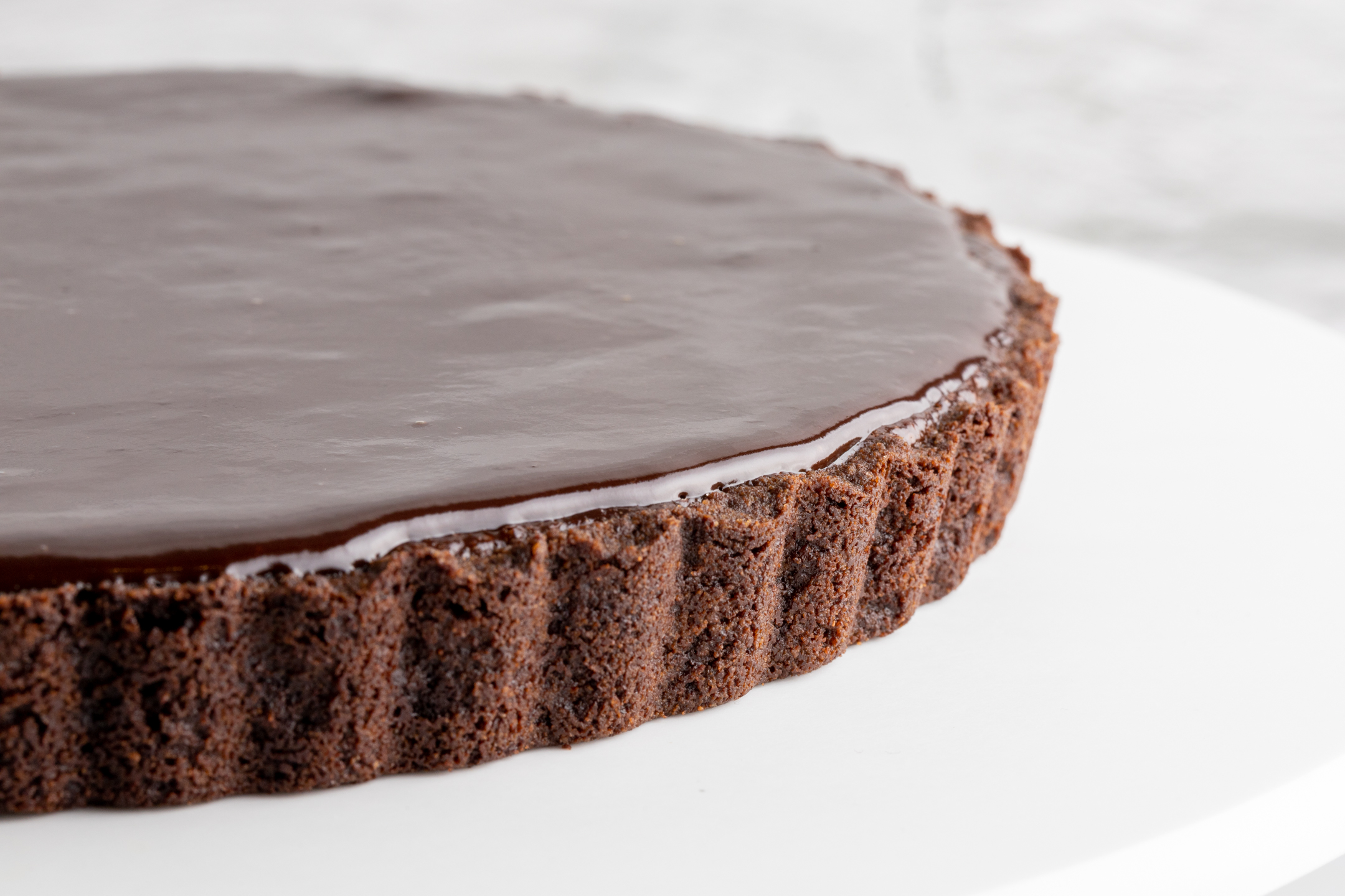 Triple Couverture Chocolate Mirror Glaze Tart slice showing rich layered chocolate interior