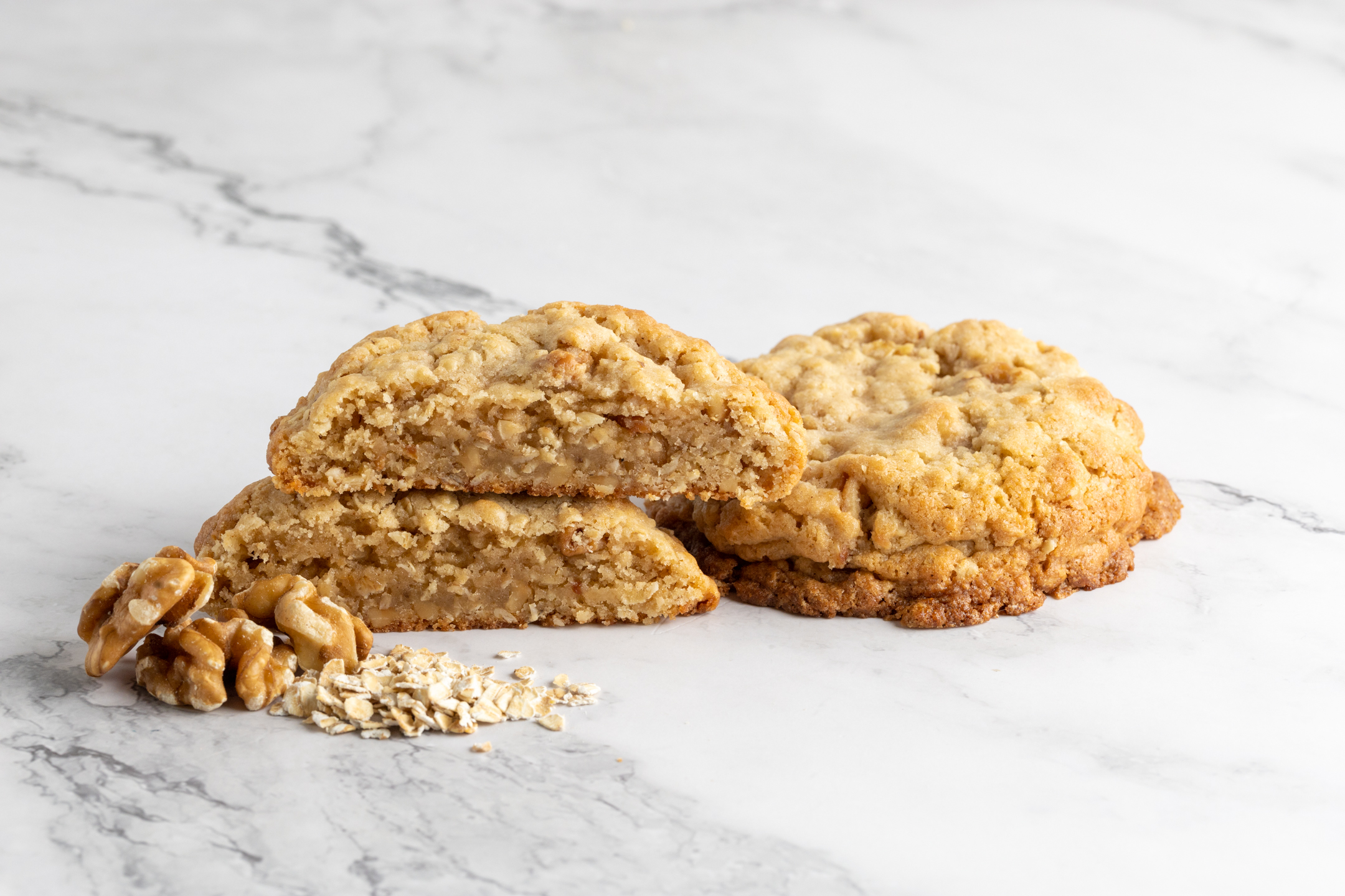 Quarter Pound Walnut Oatmeal Cookie by Sucré — golden brown exterior with soft chewy center