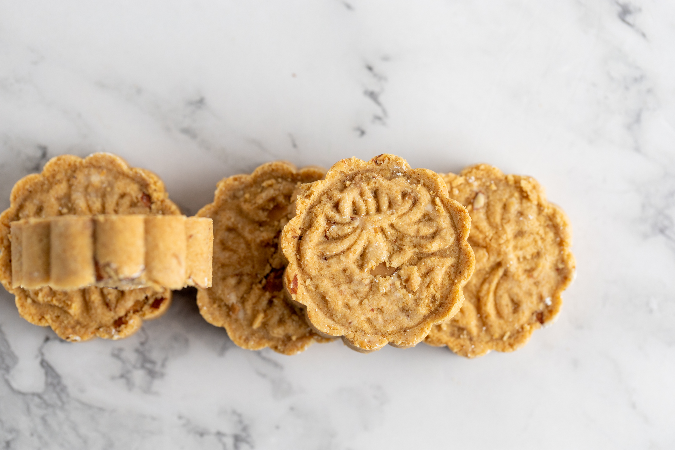 Macau Almond Cookies close-up showing decorative pressed shape and chopped almond texture