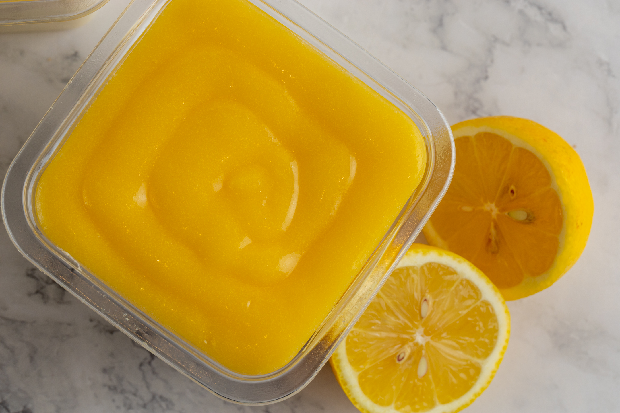 Lemon Luxe Tiramisu cross-section showing layers of lemon curd mascarpone and lemon-dipped Savoiardi