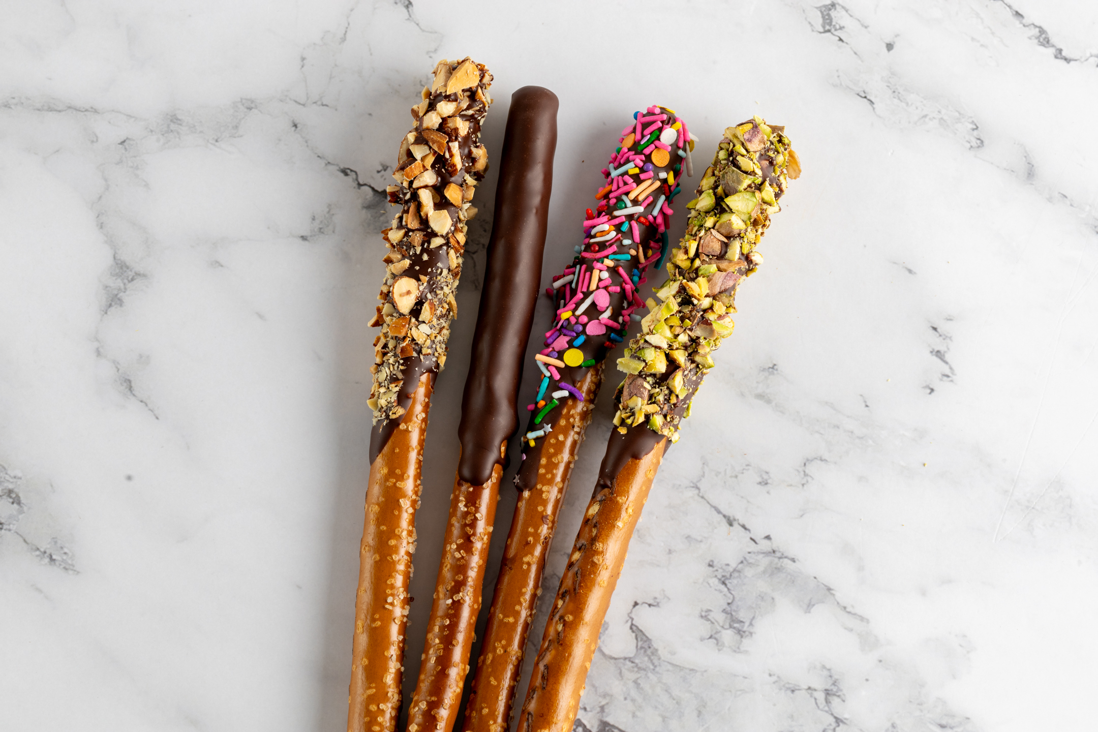 Pretzel rods dipped in Belgian couverture chocolate with pistachio topping