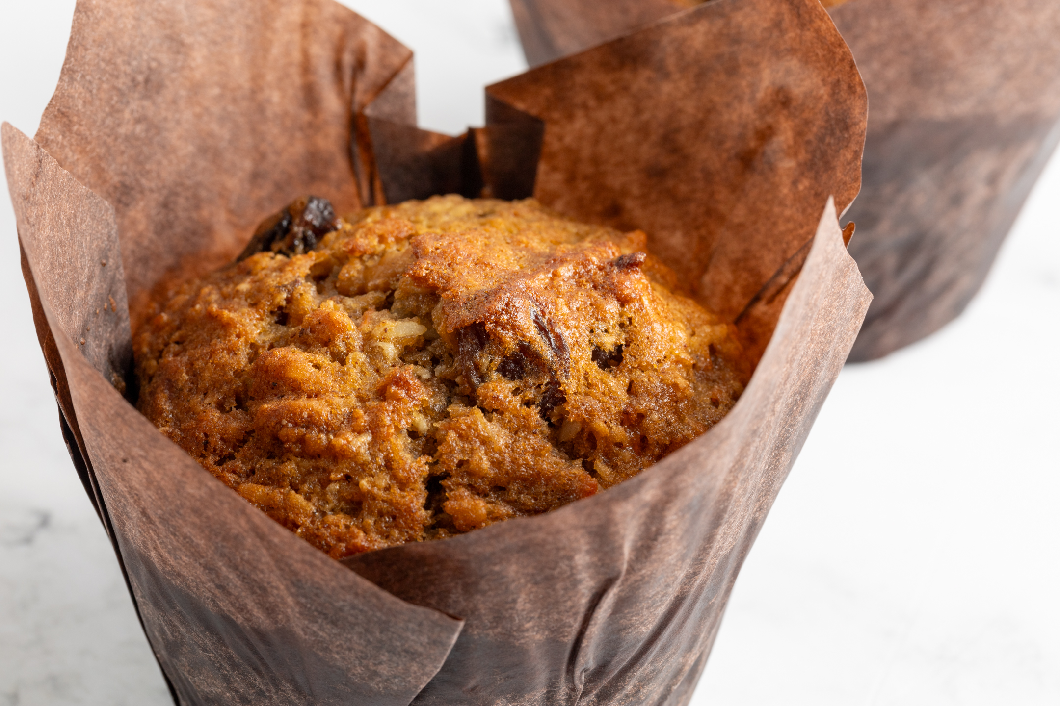 Morning Glory Muffin cross-section showing carrot and apple-studded interior
