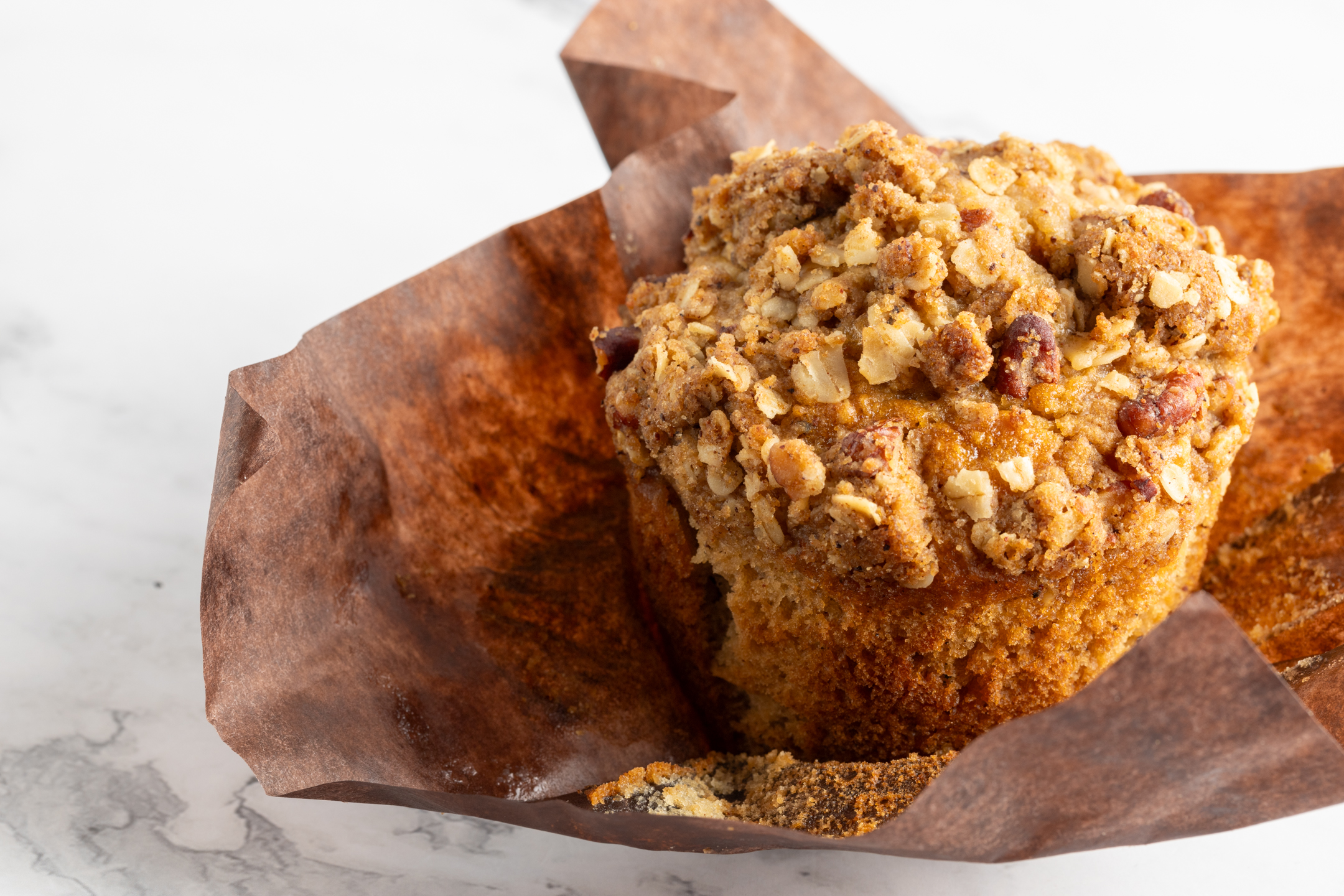 Oat and Pecan Delight Muffin by Sucré — brown sugar crumble topping with toasted pecans