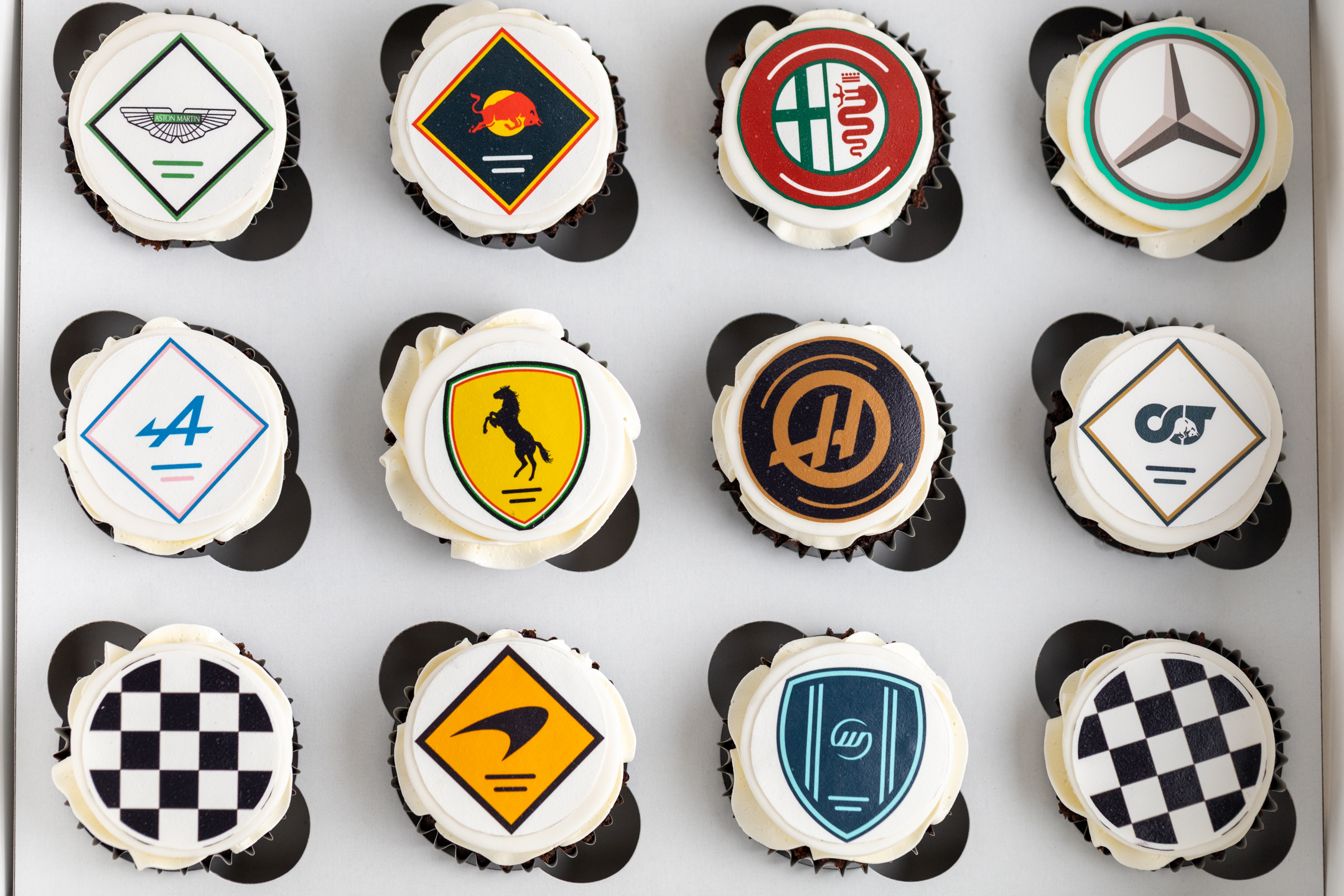 Sucré Custom Logo Cupcakes — edible printed corporate logo on Italian meringue buttercream, Toronto event cupcakes